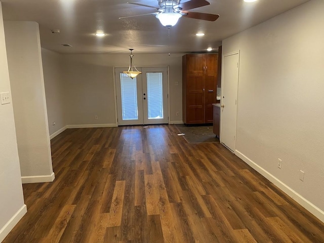 empty room with baseboards, dark wood-type flooring, and french doors