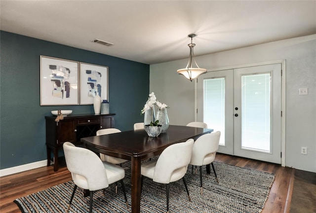 dining area featuring french doors and dark hardwood / wood-style flooring