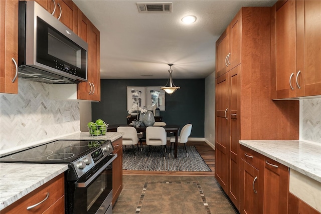 kitchen featuring decorative backsplash, hanging light fixtures, black electric range oven, and light stone counters