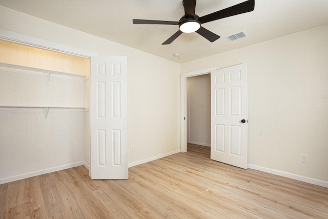 unfurnished bedroom featuring a closet, ceiling fan, and light hardwood / wood-style flooring