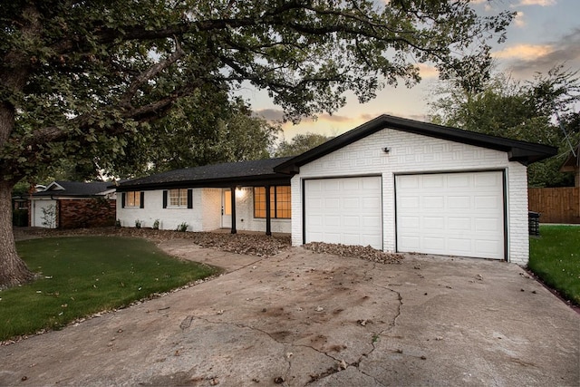 view of front facade with a garage and a yard