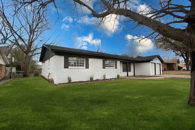 ranch-style home with brick siding, an attached garage, fence, driveway, and a front lawn