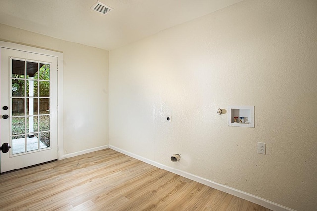 laundry room featuring light wood-type flooring, a wealth of natural light, hookup for a washing machine, and electric dryer hookup