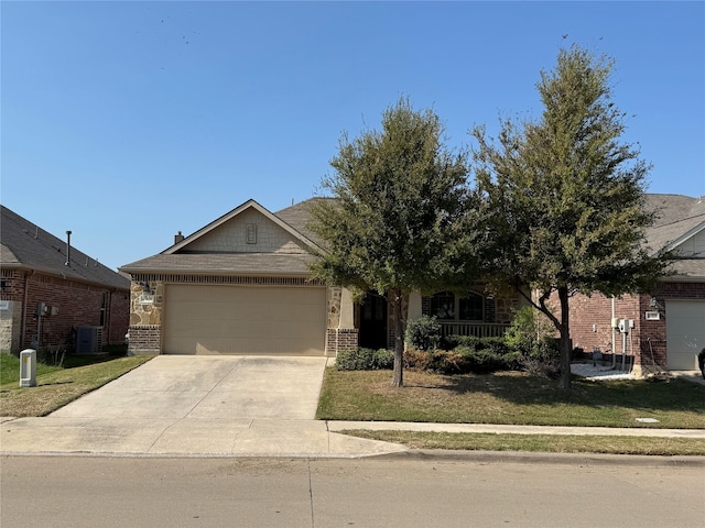 view of front of property featuring a front lawn, central AC unit, and a garage