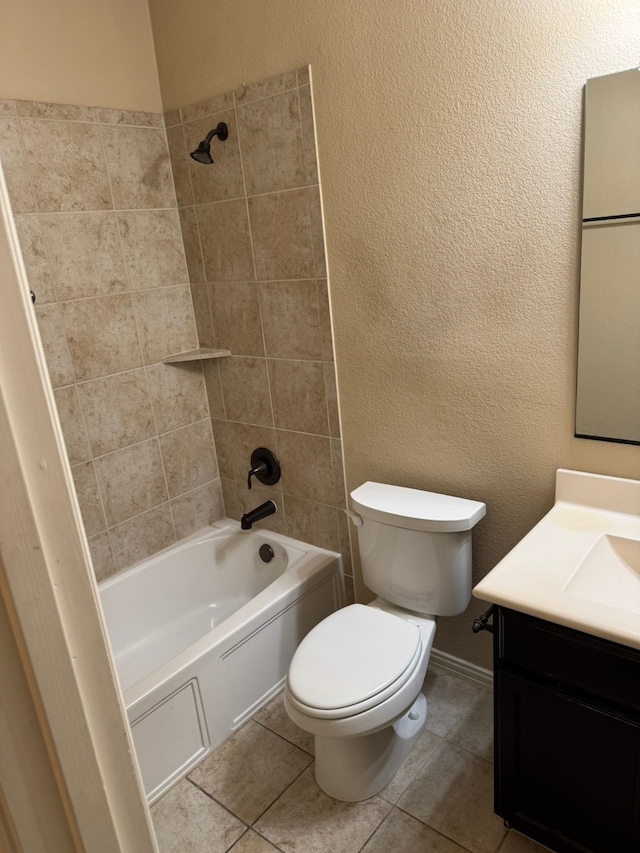 full bathroom featuring toilet, tile patterned flooring, vanity, and tiled shower / bath combo