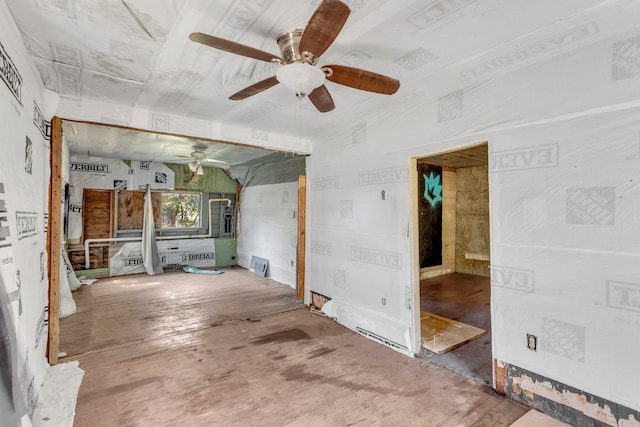 empty room with ceiling fan and wood-type flooring