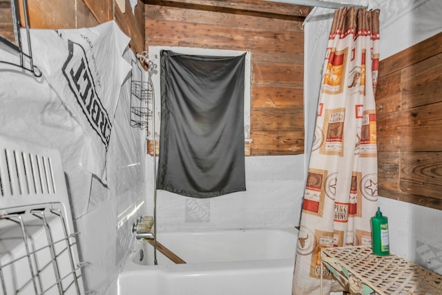 bathroom featuring radiator and wooden walls