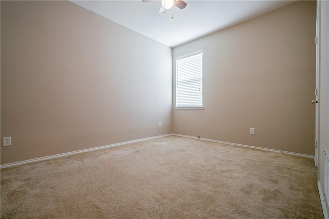 carpeted spare room featuring ceiling fan