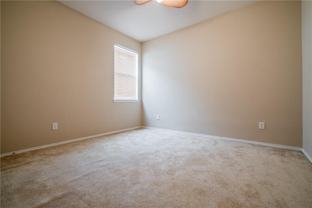 carpeted empty room featuring ceiling fan