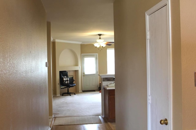 hall featuring light carpet and ornamental molding