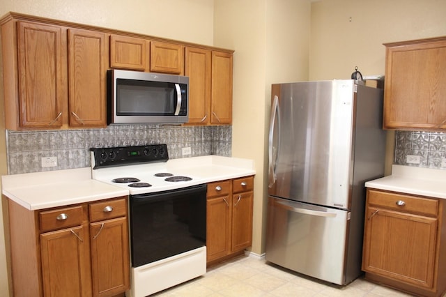 kitchen featuring stainless steel appliances and backsplash