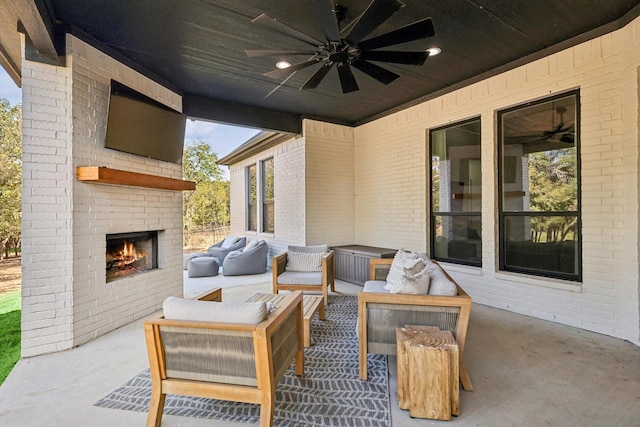 view of patio featuring an outdoor living space with a fireplace and ceiling fan