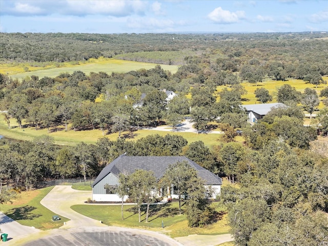 drone / aerial view with a wooded view