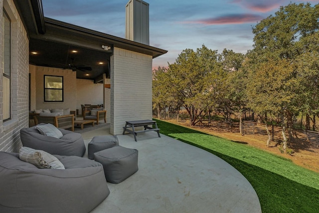 view of patio / terrace with fence, an outdoor living space, and ceiling fan