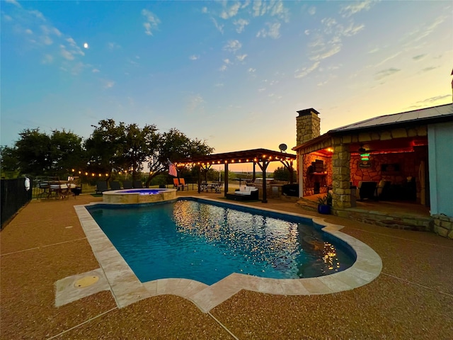 pool at dusk with a gazebo, an in ground hot tub, and a patio area