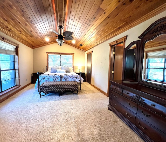 carpeted bedroom with lofted ceiling, wood ceiling, and multiple windows