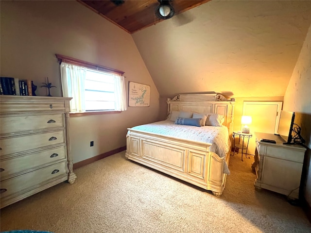 bedroom with light colored carpet, vaulted ceiling, and ceiling fan