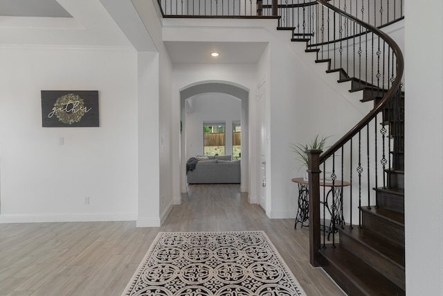 entrance foyer featuring ornamental molding and hardwood / wood-style flooring