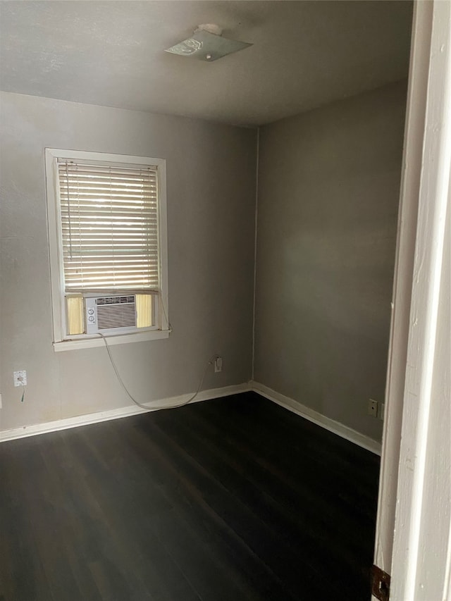 unfurnished room with dark hardwood / wood-style floors and cooling unit