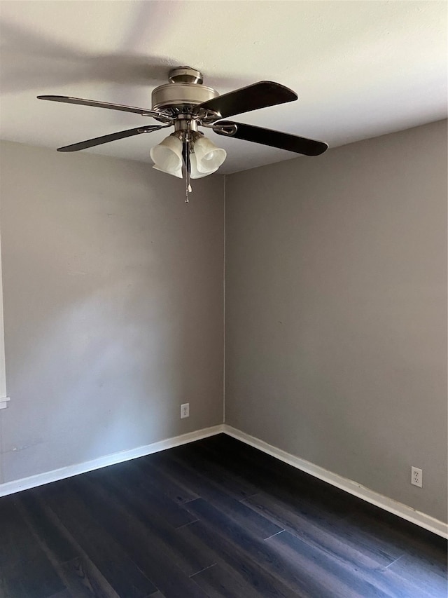 empty room with dark hardwood / wood-style floors and ceiling fan