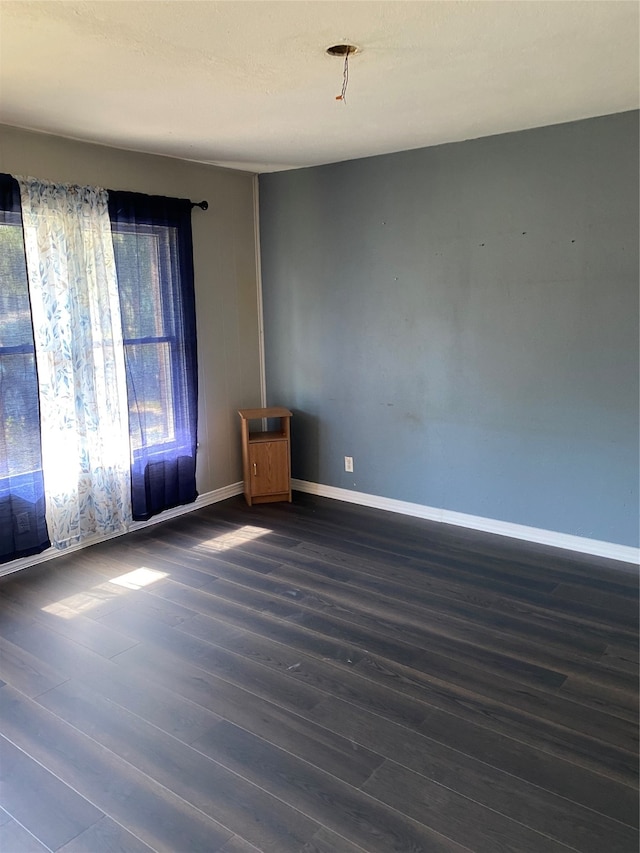 unfurnished room featuring dark hardwood / wood-style flooring