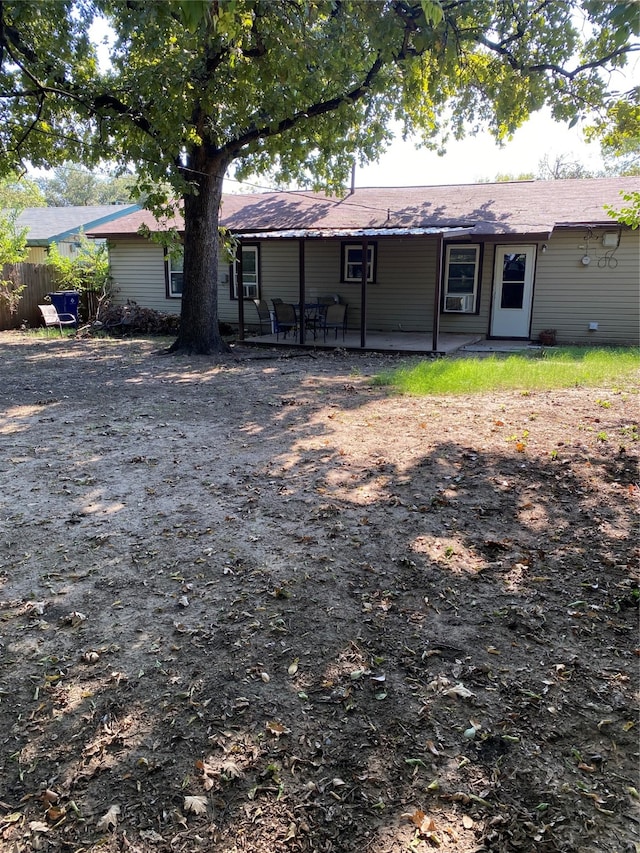 back of property with a patio