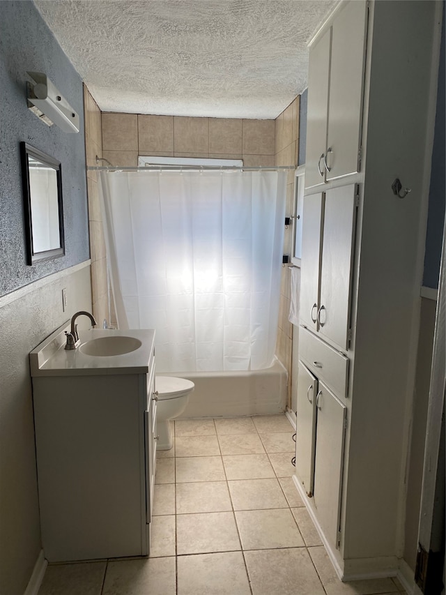 full bathroom featuring shower / bath combo, vanity, toilet, and a textured ceiling