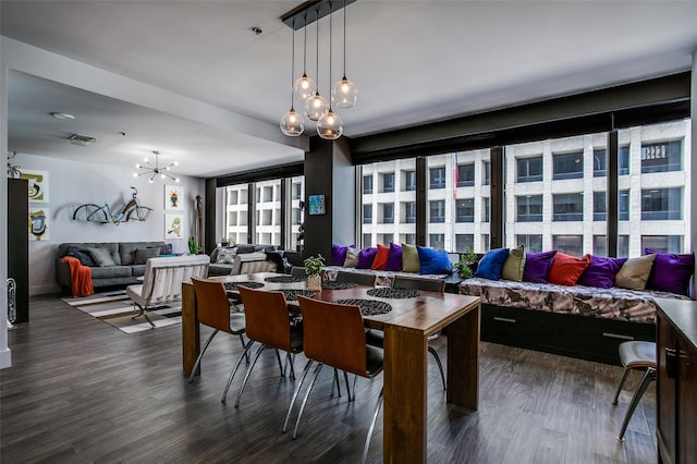 dining room with an inviting chandelier and dark wood-style flooring