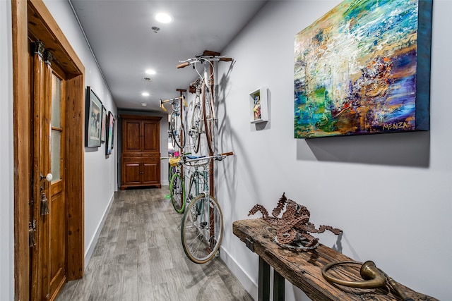 corridor with light hardwood / wood-style flooring