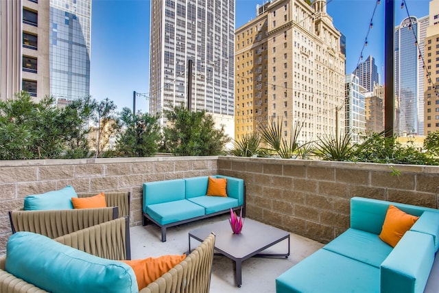 view of patio / terrace featuring a view of city and an outdoor hangout area