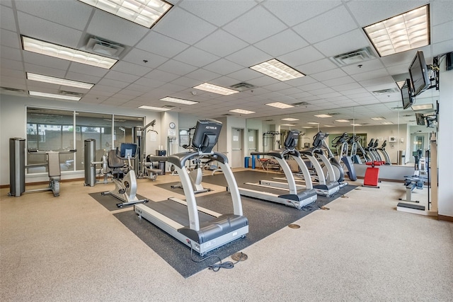 gym with a drop ceiling and carpet flooring