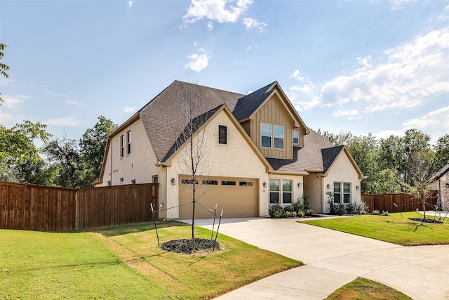 view of front of property featuring a front lawn and a garage