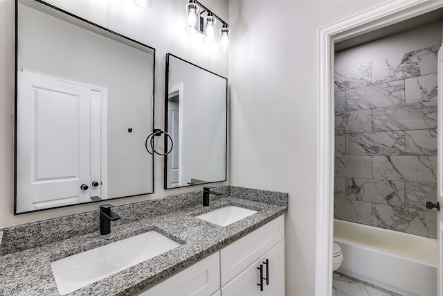 full bathroom with vanity, toilet, and tiled shower / bath combo