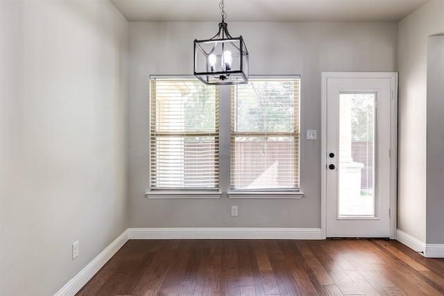 entryway with a notable chandelier and dark hardwood / wood-style floors