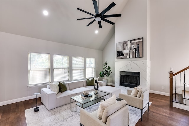 living room with hardwood / wood-style flooring, plenty of natural light, a premium fireplace, and high vaulted ceiling