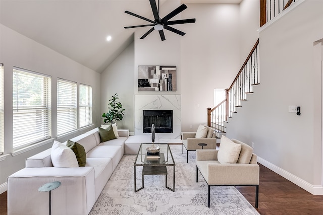 living room with a premium fireplace, high vaulted ceiling, ceiling fan, and hardwood / wood-style floors