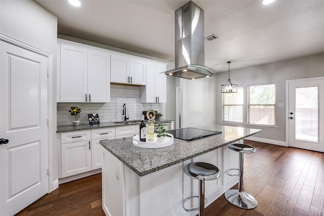 kitchen with black electric stovetop, island exhaust hood, dark wood-type flooring, and white cabinetry