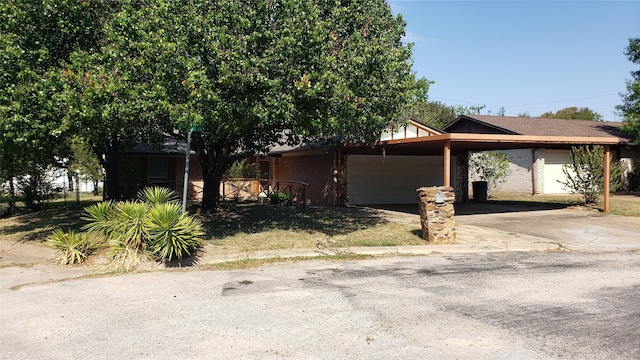 view of property hidden behind natural elements with a garage