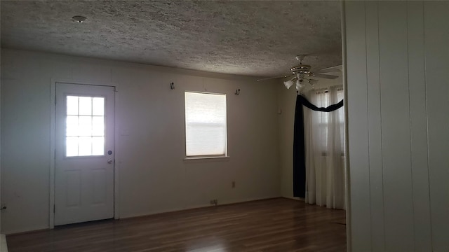 foyer with hardwood / wood-style floors, a textured ceiling, and ceiling fan