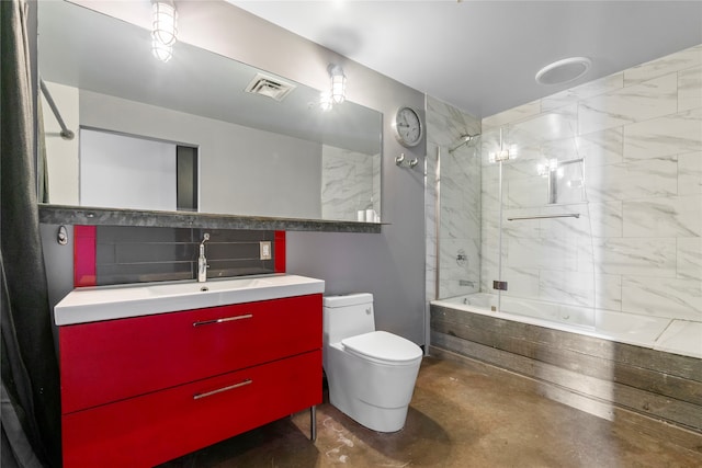 full bathroom with tiled shower / bath, vanity, toilet, and concrete floors