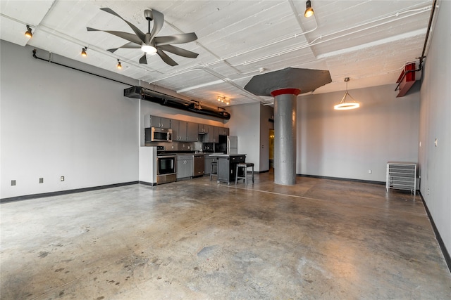 garage featuring stainless steel fridge and ceiling fan