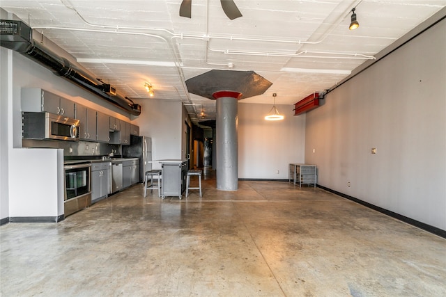 garage featuring ceiling fan and sink