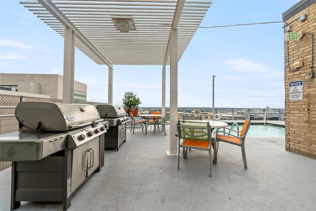 view of patio featuring area for grilling and a pergola