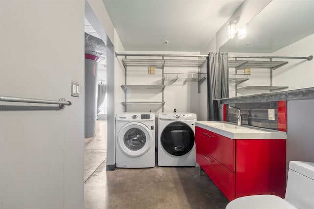 washroom featuring separate washer and dryer and sink