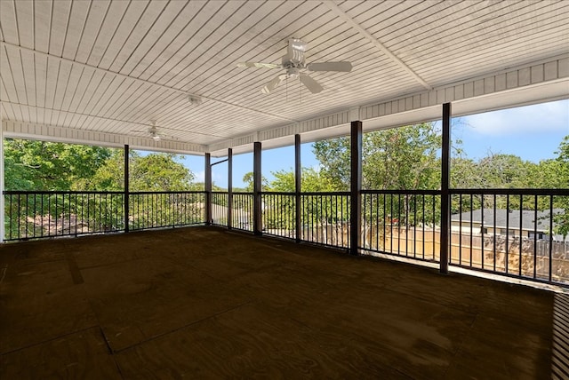 unfurnished sunroom with ceiling fan