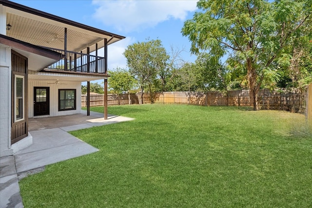 view of yard with a balcony and a patio area