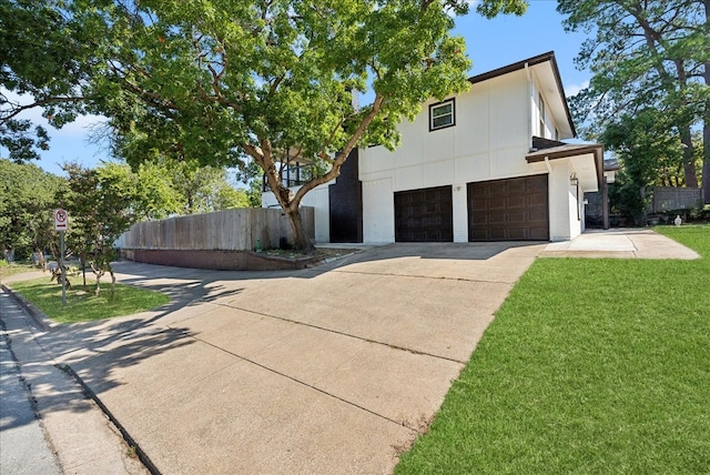 view of front of property featuring a front yard and a garage