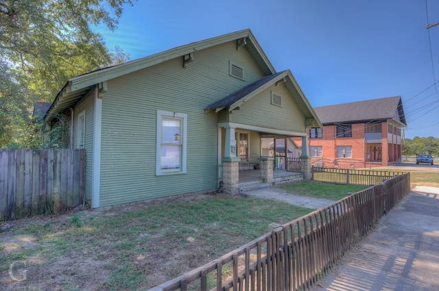 rear view of house featuring a yard