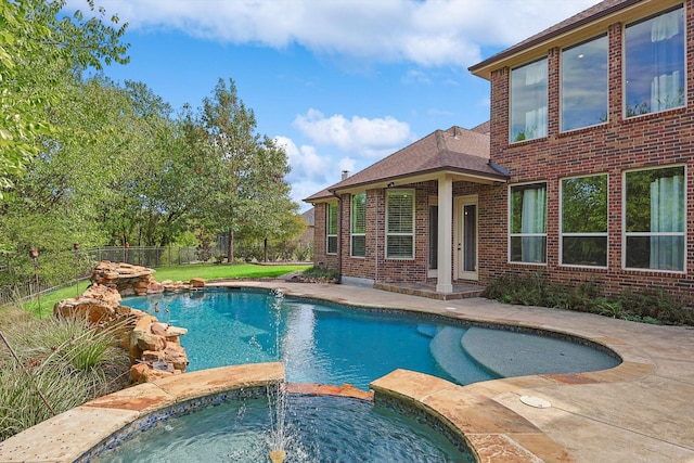 view of pool with an in ground hot tub and a patio