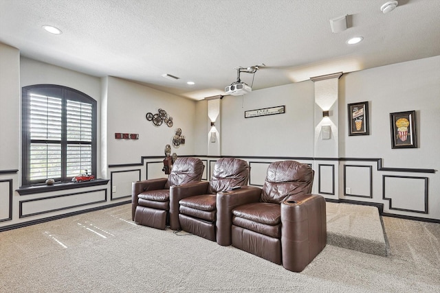 home theater featuring light carpet and a textured ceiling